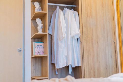 a closet with white towels hanging on it at The Song Apartment Vung Tau - Căn Hộ Du Lịch 5 Sao Cạnh Biển Vũng Tàu in Vung Tau