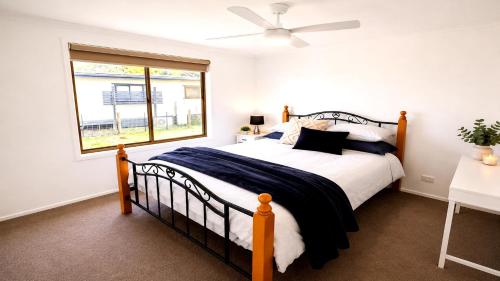 a bedroom with a bed and a window at Blue Bay Escape in Venus Bay