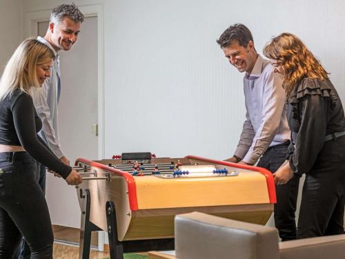 a group of people standing around a table with at ibis Styles Strasbourg Stade de la Meinau in Strasbourg