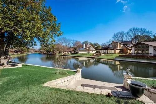 a river in a residential neighborhood with houses at Abundant life in Arlington