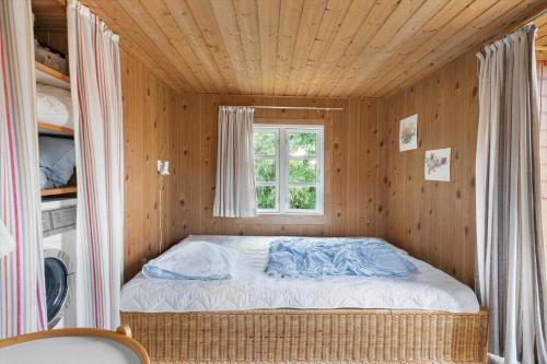 a bed in a small room with a window at 30306-Odder-Hougaardsvej-6-A in Odder