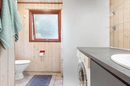 a bathroom with a toilet and a sink and a window at 30306-Odder-Hougaardsvej-6-A in Odder