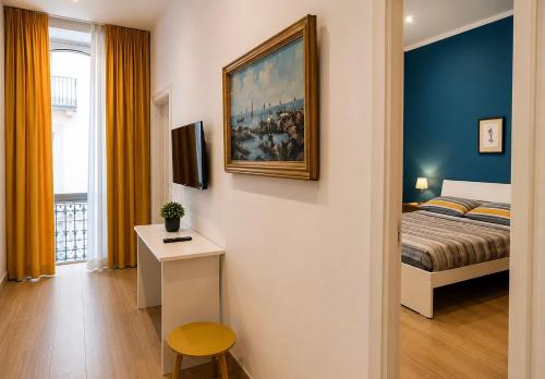 a bedroom with a bed and a painting on the wall at Relais Principe Umberto in Naples