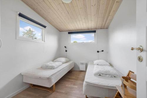 a room with two beds and a window at 40152-Juelsminde-Mirabellevej-5 in Juelsminde