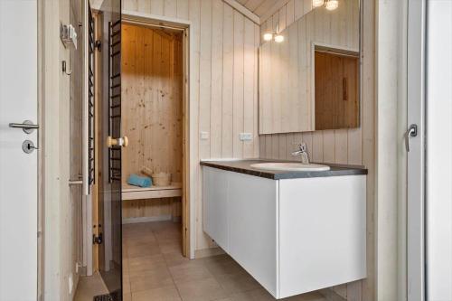 a bathroom with a sink and a mirror at 30439-Odder-Strandvaenget-74 in Odder