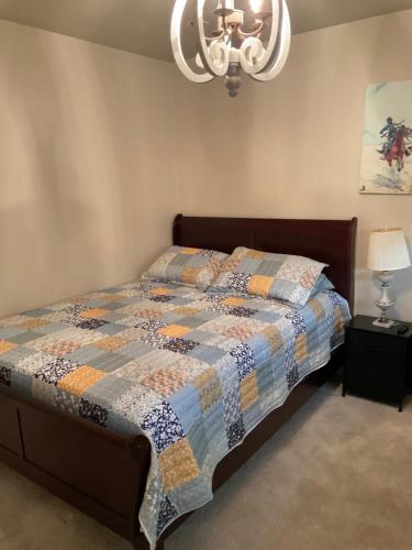a bedroom with a bed with a quilt on it at Abundant life in Arlington