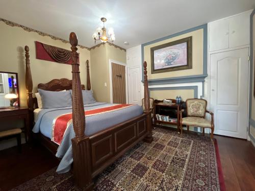 a bedroom with a bed and a chair at Barkerhouse 2# unit-heart of oldtown in Niagara-on-the-Lake
