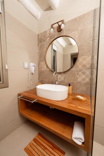 a bathroom with a sink and a mirror at Dobe Lodge in Vista Flores