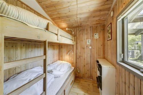 a bedroom with two bunk beds in a wooden cabin at 30312-Odder-Lyngbakkevej-29 in Odder