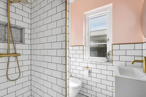 a bathroom with a toilet and a sink and a window at 30338-Odder-Skovlunden-11 in Odder