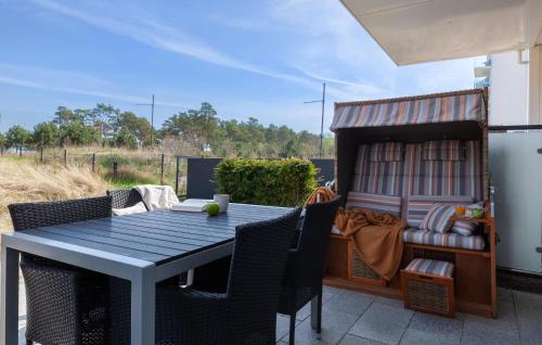 a table and chairs on a patio with a book shelf at Diamond in Binz