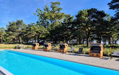a swimming pool with chaise lounge chairs next to a resort at Diamond in Binz