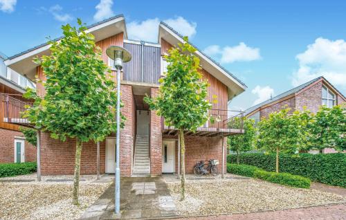 a brick building with trees in front of it at Bob Ross in Naarden