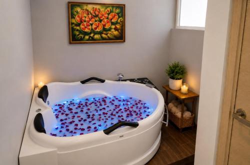a bath tub filled with lots of cherries in a bathroom at Casa Bella Boutique Hotel in Antigua Guatemala