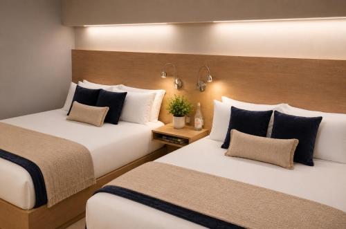 two beds in a hotel room with sidx sidx sidx sidx at Casa Bella Boutique Hotel in Antigua Guatemala