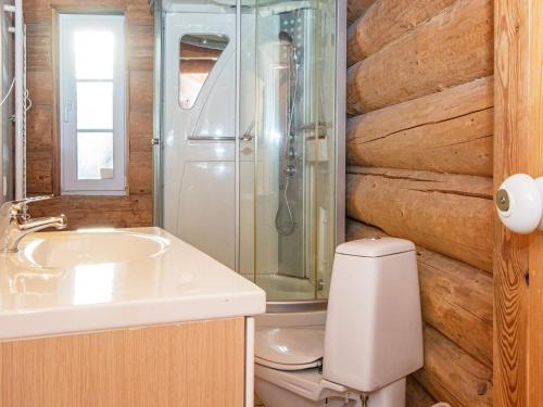 a bathroom with a toilet and a shower and a sink at Holiday home with pool in Ansager in Ansager