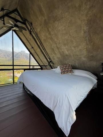 a bed in a room with a large window at Macpalo in Amatlán