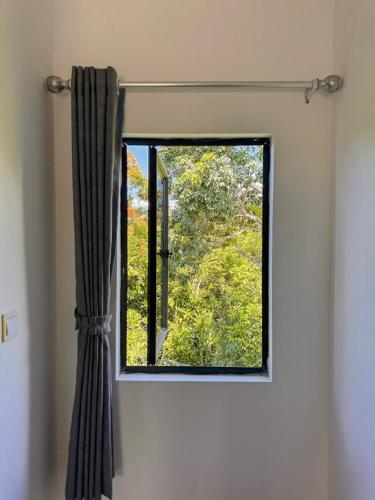 a window in a room with a curtain at The Up Koh Rong in Kaôh Rŭng (3)