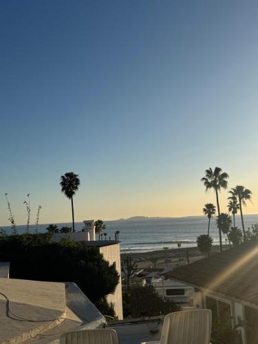 a view of a beach with palm trees and the ocean at Beach house in San Miguel, Ensenada in Ensenada