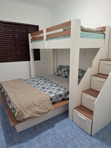 a bedroom with two bunk beds and a staircase at Casa c Piscina em Holambra in Holambra