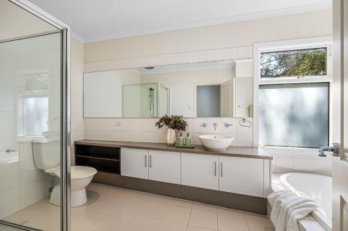a white bathroom with a toilet and a sink at Guest room in Stirling in Stirling