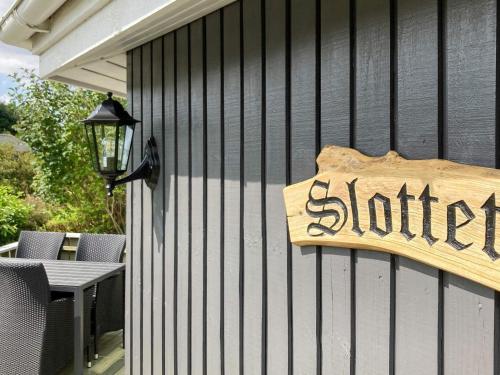 a sign on the side of a building with a patio at 4 person holiday home in Vinderup in Vinderup