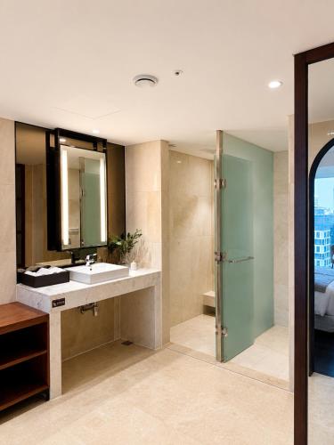 a bathroom with a sink and a shower at Western Palace Hotel in Incheon