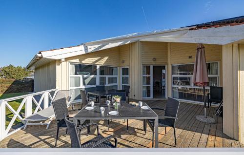 a patio with a table and chairs on a deck at Strandpark 9 in Schönhagen