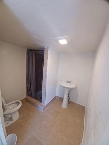 a bathroom with a toilet and a sink at Sunset Motel in Las Vegas