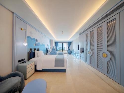 a bedroom with a large bed and a balcony at Doubletree By Hilton Sanya Bay in Sanya