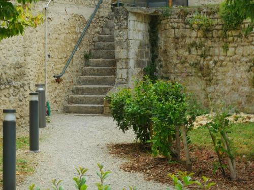 a set of stairs in a stone building with a staircase at Aparthotel Adagio Access Poitiers in Poitiers