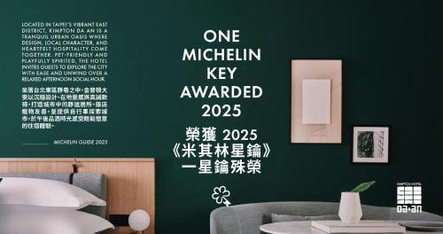 a bedroom with a green wall with white writing on it at Kimpton Da An Taipei by IHG in Taipei