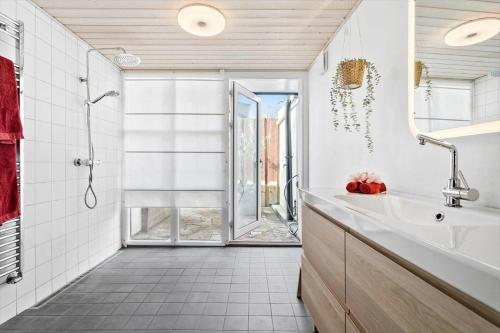 a bathroom with a tub and a sink and a shower at 20611-Samso-Brundby-Hovedgade-66 in Brundby