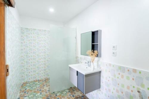 a bathroom with a sink and a mirror at Arc Villas Bali in Ketewel