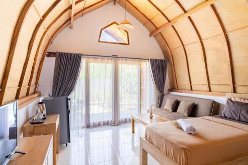 a living room with a couch and a tv at Arc Villas Bali in Ketewel