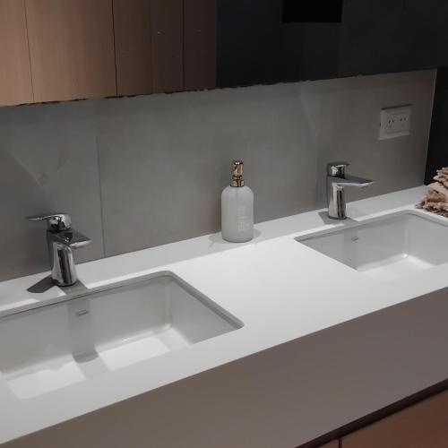 a bathroom with two sinks and a soap dispenser at VICTORIA BED and BREAKFAST 1 A 3KM AEROPUERTO EZEIZA in Ezeiza