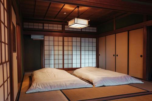 a bedroom with a large bed in a room at Kumano Base in Tanabe