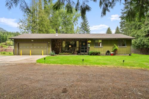 a house with a garage and a driveway at Cedar Trees Retreat in Sandpoint