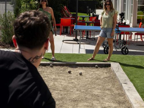 a group of people playing a game of ping pong at ibis budget Strasbourg Sud Illkirch in Geispolsheim