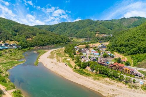 an aerial view of a resort next to a river at Hongcheon Ganggaae in Hongcheon