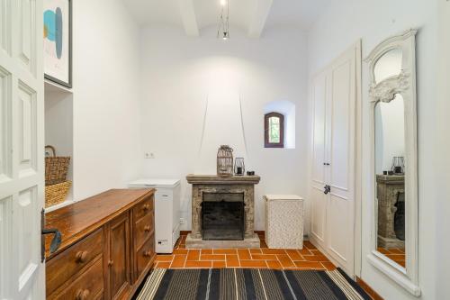 a kitchen with a fireplace in a room at Luxury Villa El Turo in Castellví de Rosanés