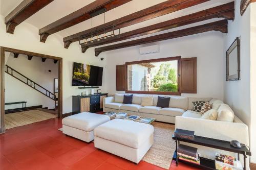 a living room with white couches and a tv at Luxury Villa El Turo in Castellví de Rosanés