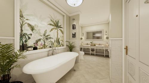 a white bathroom with a tub and two sinks at Villa Santi Hotel in Luang Prabang
