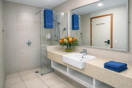 a bathroom with a sink and a shower at Banksia Hideaway Kgari in Fraser Island