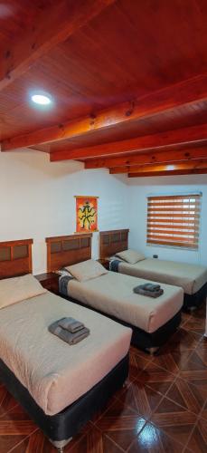 a room with four beds in a room at Lalck Cketi Hotelería y Turismo in San Pedro de Atacama