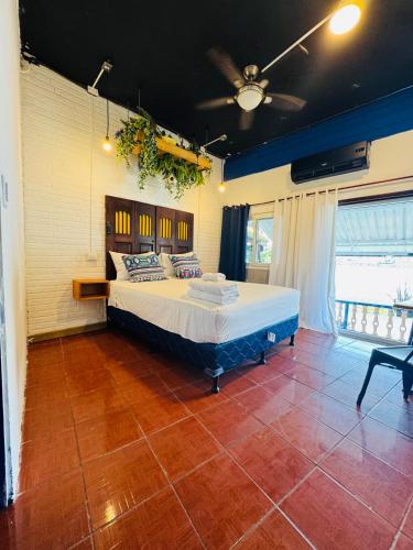 a bedroom with a large bed in a room at Maple Guest House in Flores