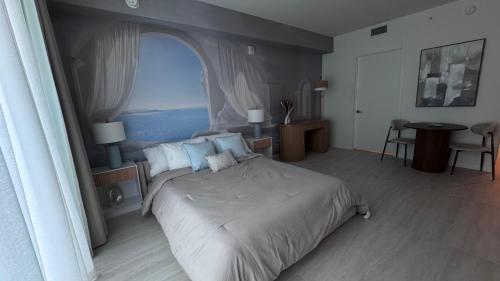 a bedroom with a large bed with a large window at Viceroy Residences in Miami