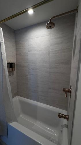a white bath tub in a bathroom with a shower at Viceroy Residences in Miami