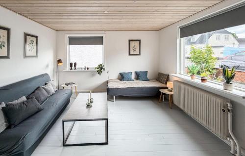 a living room with a couch and a window at Beautiful Home In Allinge With Wifi in Allinge