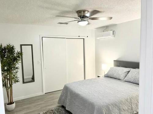 a bedroom with a bed and a ceiling fan at Brisa Marina Suites in New Port Richey